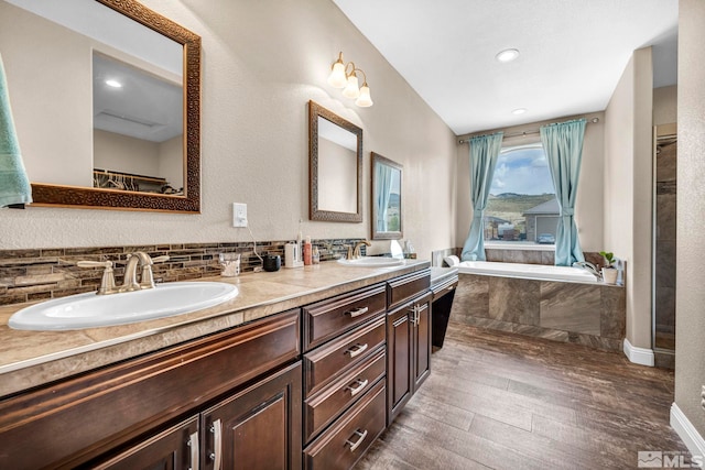16885 Majestic View Dr, Reno, NV 89521 - bathroom featuring wood finished floors, a garden tub, double vanity, and recessed lighting
