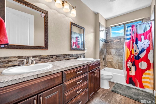 16885 Majestic View Dr, Reno, NV 89521 - bathroom featuring wood finished floors, double vanity, backsplash, shower / tub combo, and toilet