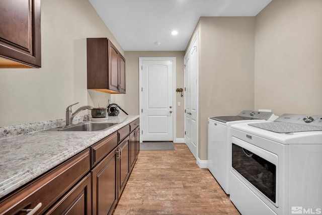16885 Majestic View Dr, Reno, NV 89521 - clothes washing area with washing machine and dryer, light wood-type flooring, cabinet space, recessed lighting, and baseboards