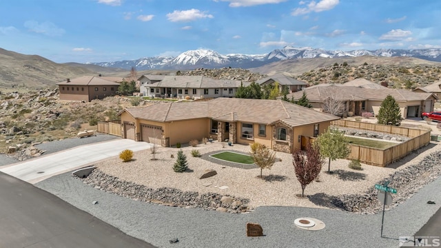 16885 Majestic View Dr, Reno, NV 89521 - view of front facade with an attached garage, a mountain view, concrete driveway, and a tile roof