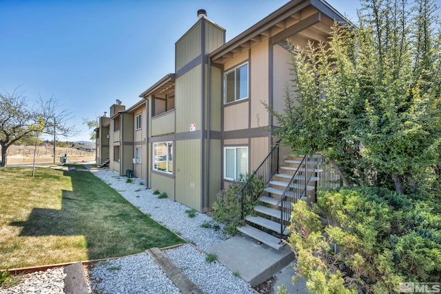 2375 Tripp Dr Unit 2, Reno, NV 89512 - view of side of property with a chimney, a yard, and stairs