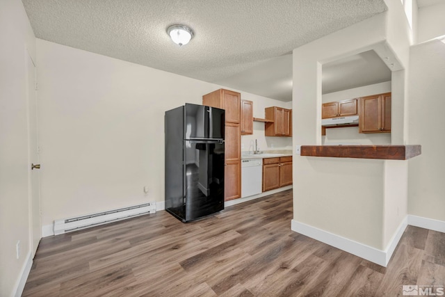 2375 Tripp Dr Unit 2, Reno, NV 89512 - kitchen featuring freestanding refrigerator, dishwasher, baseboard heating, under cabinet range hood, and wood finished floors