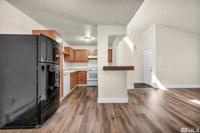 2375 Tripp Dr Unit 2, Reno, NV 89512 - kitchen with white appliances, under cabinet range hood, dark wood-style flooring, baseboards, and a textured ceiling
