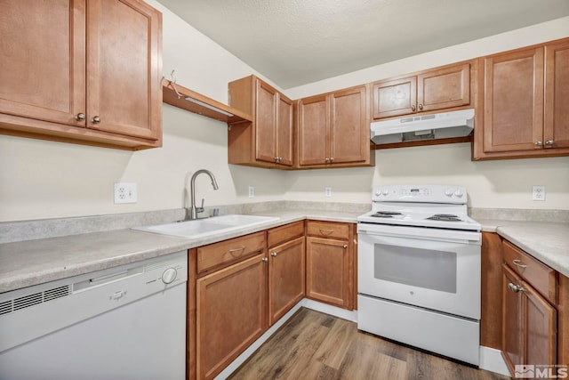 2375 Tripp Dr Unit 2, Reno, NV 89512 - kitchen featuring white appliances, under cabinet range hood, a sink, light wood finished floors, and light countertops