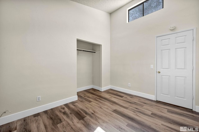 2375 Tripp Dr Unit 2, Reno, NV 89512 - unfurnished bedroom featuring baseboards, wood finished floors, a textured ceiling, and a closet