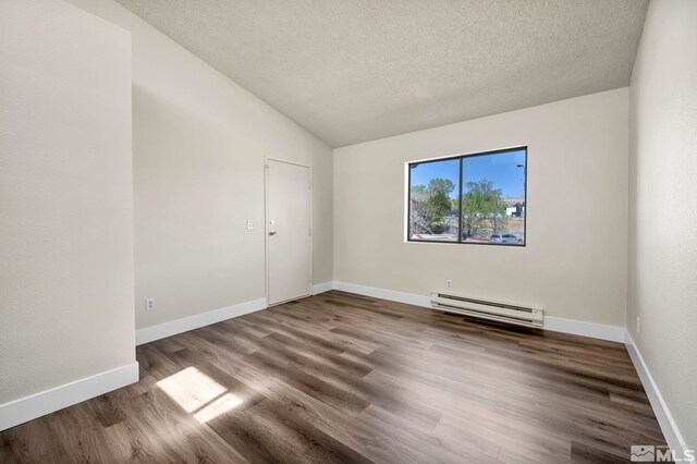 2375 Tripp Dr Unit 2, Reno, NV 89512 - spare room with a baseboard heating unit, wood finished floors, a textured ceiling, lofted ceiling, and baseboards