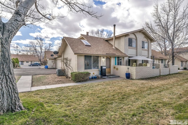 40 Condor Cir, Carson City, NV 89701 - rear view of house featuring stucco siding, a yard, a chimney, and roof with shingles