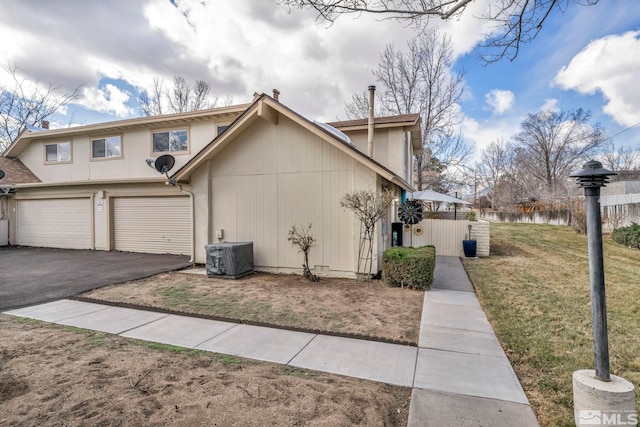 40 Condor Cir, Carson City, NV 89701 - view of property exterior with central air condition unit, driveway, and a garage