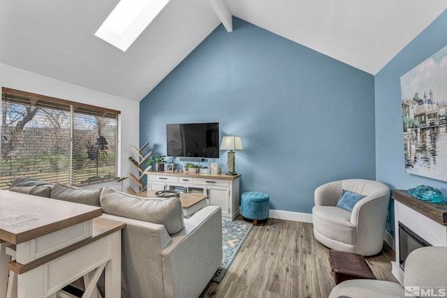 40 Condor Cir, Carson City, NV 89701 - living room featuring a skylight, light wood-style floors, high vaulted ceiling, baseboards, and beamed ceiling