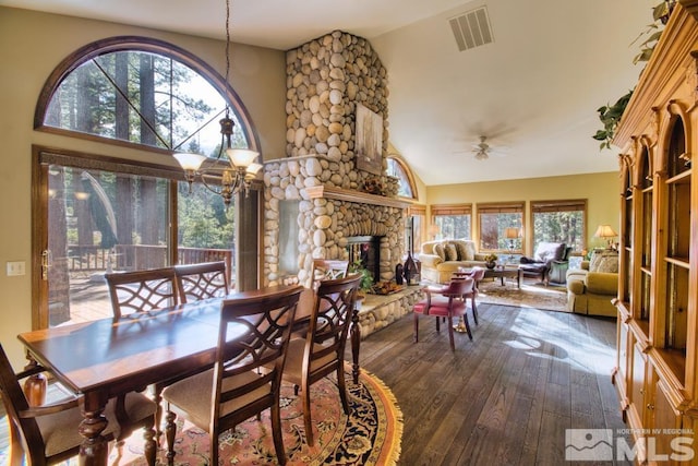 1300 Douglas Fir Dr, Reno, NV 89511 - dining space featuring dark wood-style flooring, high vaulted ceiling, a ceiling fan, and a stone fireplace