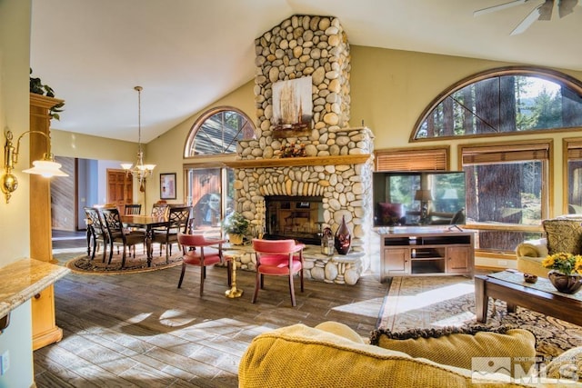 1300 Douglas Fir Dr, Reno, NV 89511 - living area with wood-type flooring, a ceiling fan, a stone fireplace, a chandelier, and high vaulted ceiling