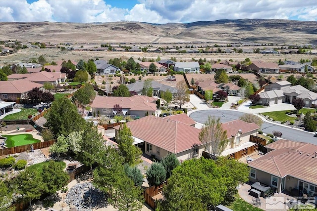 aerial view of residential area featuring a mountain backdrop