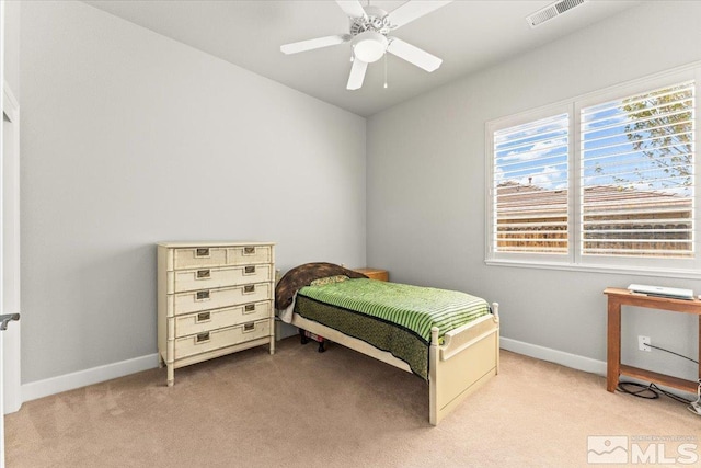 bedroom featuring light colored carpet, baseboards, and ceiling fan