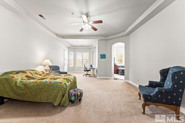 carpeted bedroom featuring arched walkways, baseboards, and a ceiling fan