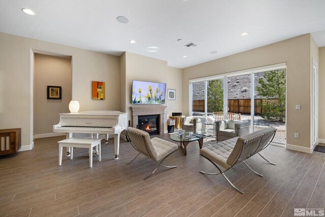 3335 Show Jumper, Reno, NV 89521 - living room featuring baseboards, wood finished floors, a glass covered fireplace, and recessed lighting