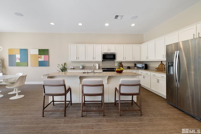 3335 Show Jumper, Reno, NV 89521 - kitchen with stainless steel appliances, a sink, dark wood-style flooring, white cabinetry, and recessed lighting