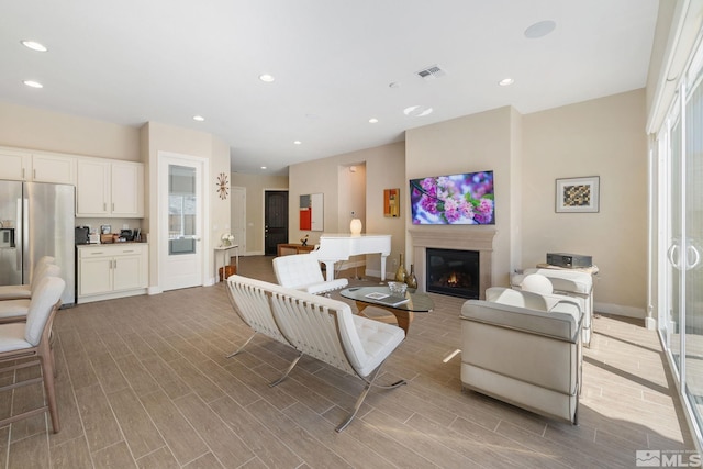 3335 Show Jumper, Reno, NV 89521 - living area with wood finished floors, a glass covered fireplace, baseboards, and recessed lighting