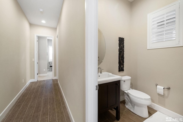 3335 Show Jumper, Reno, NV 89521 - half bathroom with wood finished floors, toilet, baseboards, vanity, and recessed lighting