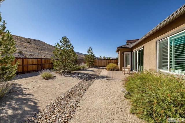 3335 Show Jumper, Reno, NV 89521 - fenced backyard with a patio and a mountain view
