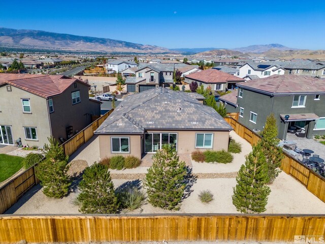 3335 Show Jumper, Reno, NV 89521 - back of property featuring a residential view, a mountain view, a fenced backyard, and stucco siding