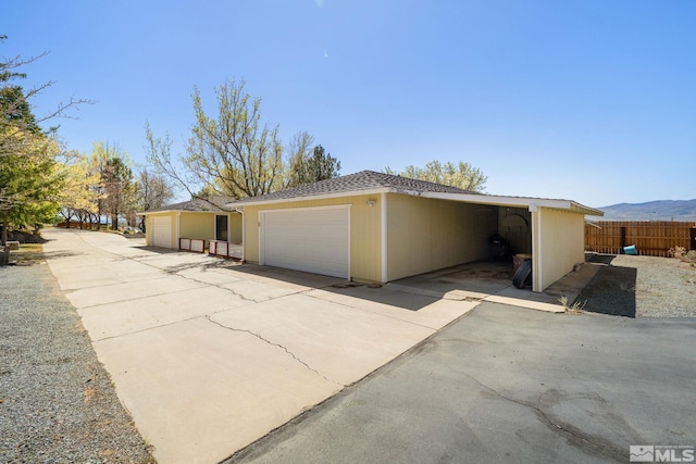 9499 Wigwam Way, Reno, NV 89506 - view of home's exterior featuring fence and a detached garage