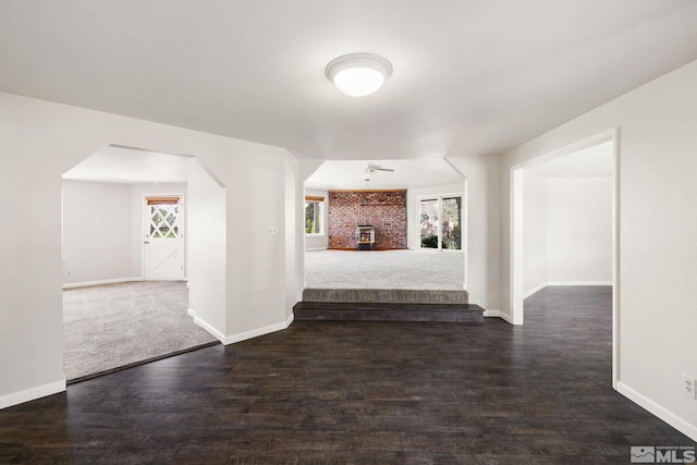 9499 Wigwam Way, Reno, NV 89506 - interior space featuring arched walkways, baseboards, and dark wood finished floors