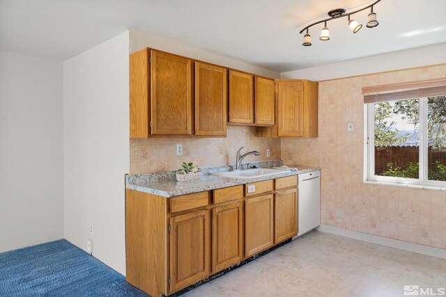 9499 Wigwam Way, Reno, NV 89506 - kitchen with a sink, light countertops, white dishwasher, and brown cabinetry