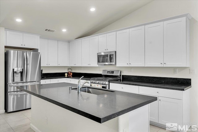 286 Greywall Ct, Dayton, NV 89403 - kitchen featuring appliances with stainless steel finishes, a sink, vaulted ceiling, dark countertops, and light tile patterned flooring