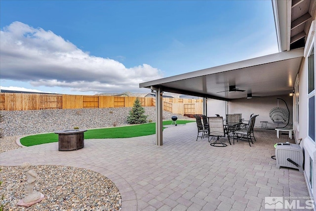 286 Greywall Ct, Dayton, NV 89403 - view of patio featuring a fenced backyard, outdoor dining space, a fire pit, and ceiling fan
