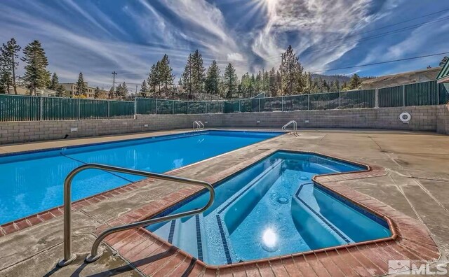 416 Quaking Aspen Ln Unit P, Stateline, NV 89449 - community pool featuring a community hot tub, a fenced backyard, and a patio