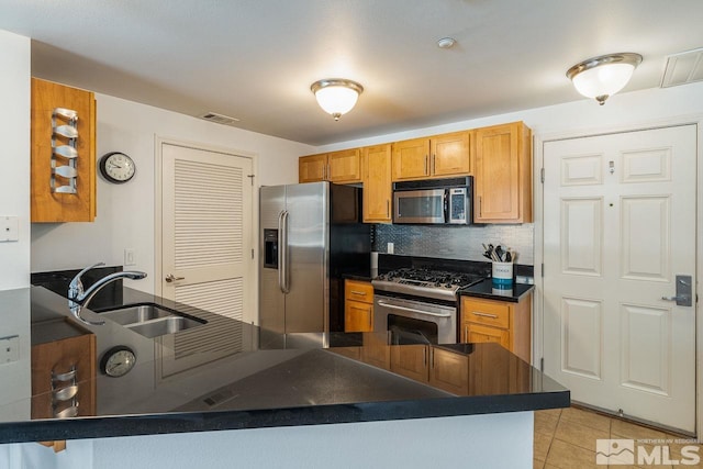 1450 Idlewild Dr Unit 1121, Reno, NV 89509 - kitchen with appliances with stainless steel finishes, a sink, dark countertops, tasteful backsplash, and light tile patterned floors