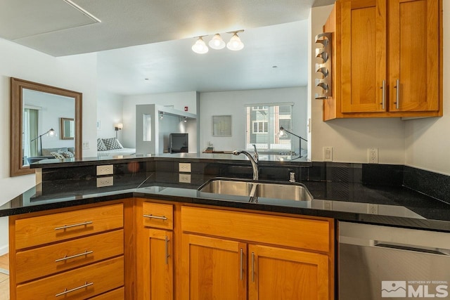 1450 Idlewild Dr Unit 1121, Reno, NV 89509 - kitchen featuring stainless steel dishwasher, a sink, brown cabinetry, dark stone counters, and open floor plan