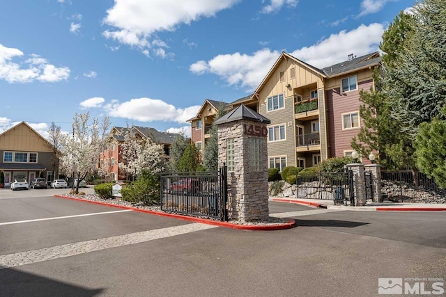 1450 Idlewild Dr Unit 1121, Reno, NV 89509 - view of asphalt street featuring curbs, a gated entry, and a gate