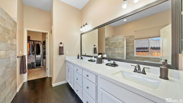 2485 Firenze Dr, Sparks, NV 89434 - full bath with wood finished floors, double vanity, a walk in shower, a walk in closet, and baseboards
