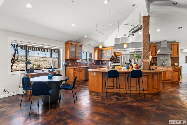 4625 Canyon Dr, Reno, NV 89519 - kitchen featuring wall chimney range hood, concrete floors, brown cabinets, recessed lighting, and high vaulted ceiling