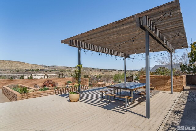 4625 Canyon Dr, Reno, NV 89519 - wooden deck with a pergola, a fenced backyard, and a mountain view