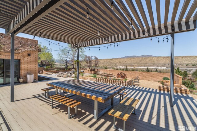 4625 Canyon Dr, Reno, NV 89519 - wooden terrace with a pergola, a mountain view, and outdoor dining area