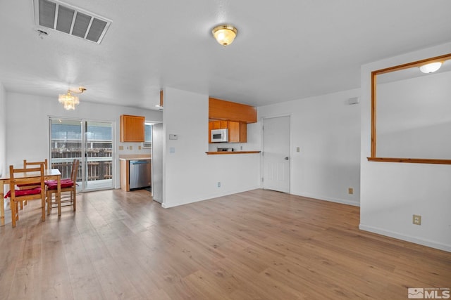 846 Long Valley Rd, Gardnerville, NV 89460 - living area with a chandelier, light wood-style floors, and baseboards