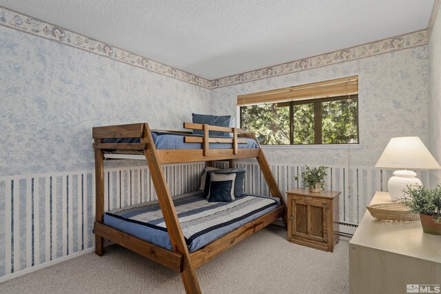 321 Ski Way Unit 148, Incline Village, NV 89451 - carpeted bedroom with wallpapered walls, a baseboard heating unit, and a textured ceiling