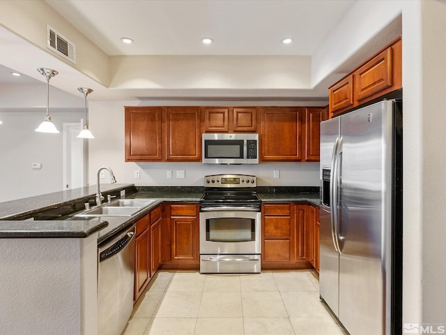 200 W 2nd Unit 1508, Reno, NV 89501 - kitchen with stainless steel appliances, a sink, a peninsula, brown cabinetry, and light tile patterned floors