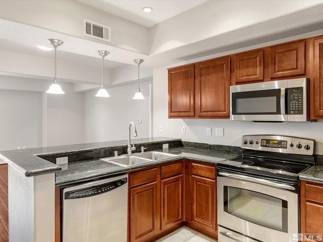 200 W 2nd Unit 1508, Reno, NV 89501 - kitchen with stainless steel appliances, a sink, a peninsula, brown cabinetry, and recessed lighting