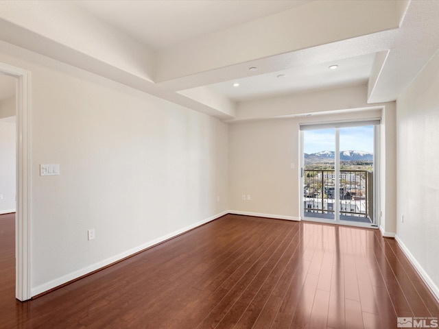 200 W 2nd Unit 1508, Reno, NV 89501 - unfurnished room with dark wood-style floors, a mountain view, and baseboards
