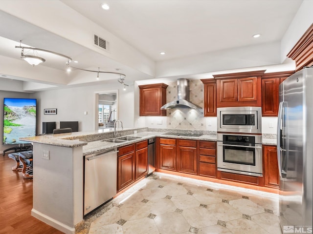 200 W 2nd Unit 1104, Reno, NV 89501 - kitchen with stainless steel appliances, a sink, wall chimney exhaust hood, a peninsula, and open floor plan