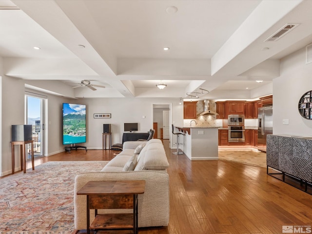 200 W 2nd Unit 1104, Reno, NV 89501 - living area featuring light wood-style floors, recessed lighting, beam ceiling, ceiling fan, and baseboards