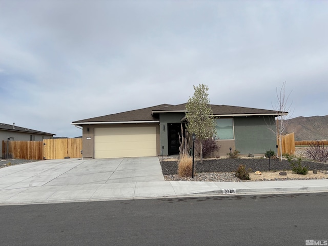 2269 Millville Dr, Sparks, NV 89441 - view of front of home with stucco siding, a garage, driveway, and fence