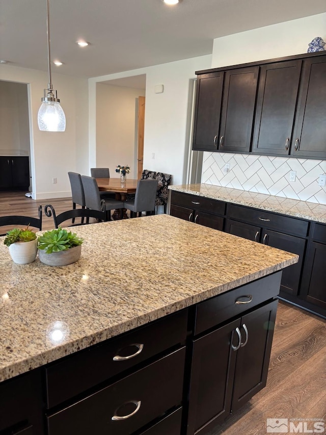 2269 Millville Dr, Sparks, NV 89441 - kitchen with wood finished floors, light stone counters, tasteful backsplash, pendant lighting, and recessed lighting