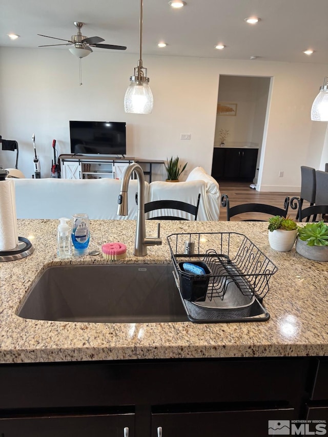 2269 Millville Dr, Sparks, NV 89441 - kitchen featuring open floor plan, a ceiling fan, light stone countertops, wood finished floors, and recessed lighting