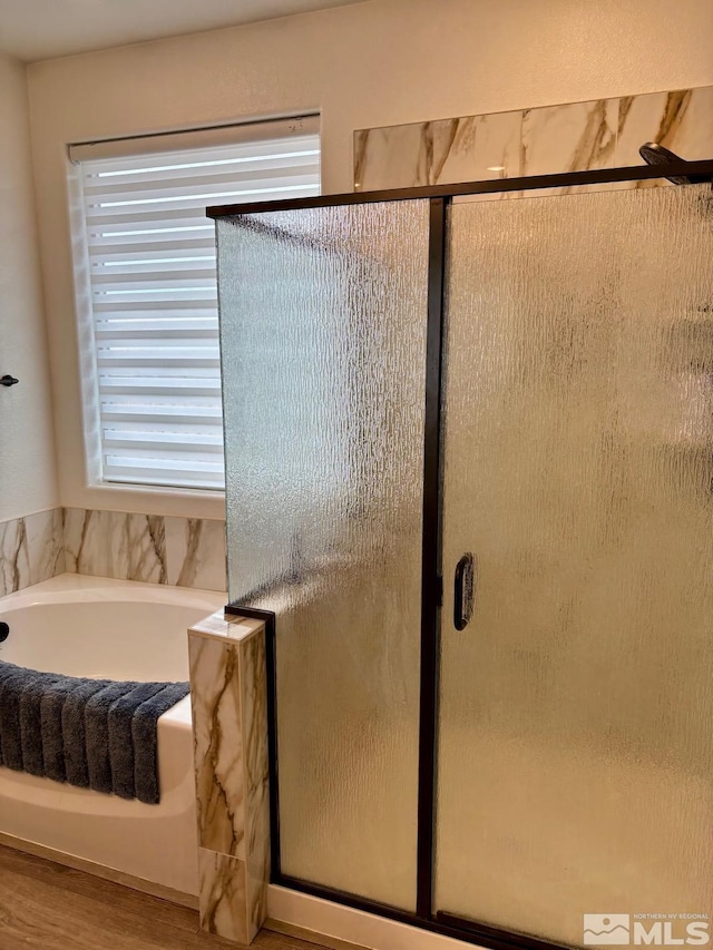 2269 Millville Dr, Sparks, NV 89441 - bathroom with a stall shower, a bath, and wood finished floors