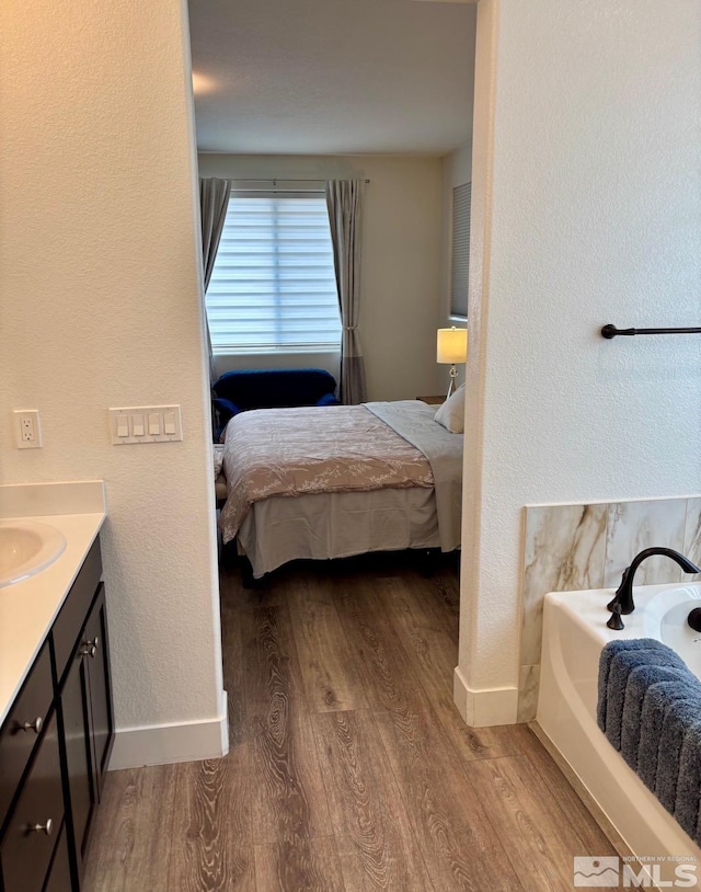2269 Millville Dr, Sparks, NV 89441 - bedroom with wood finished floors, baseboards, and a sink