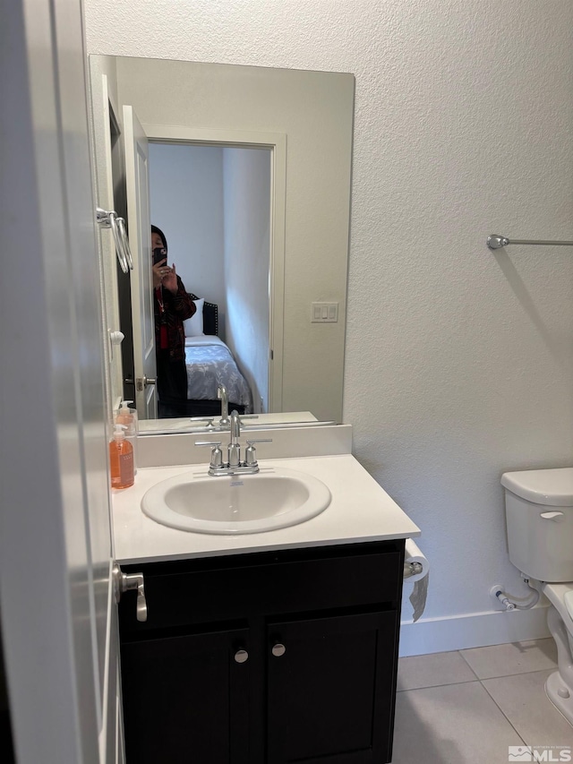 2269 Millville Dr, Sparks, NV 89441 - ensuite bathroom with tile patterned floors, toilet, vanity, and baseboards